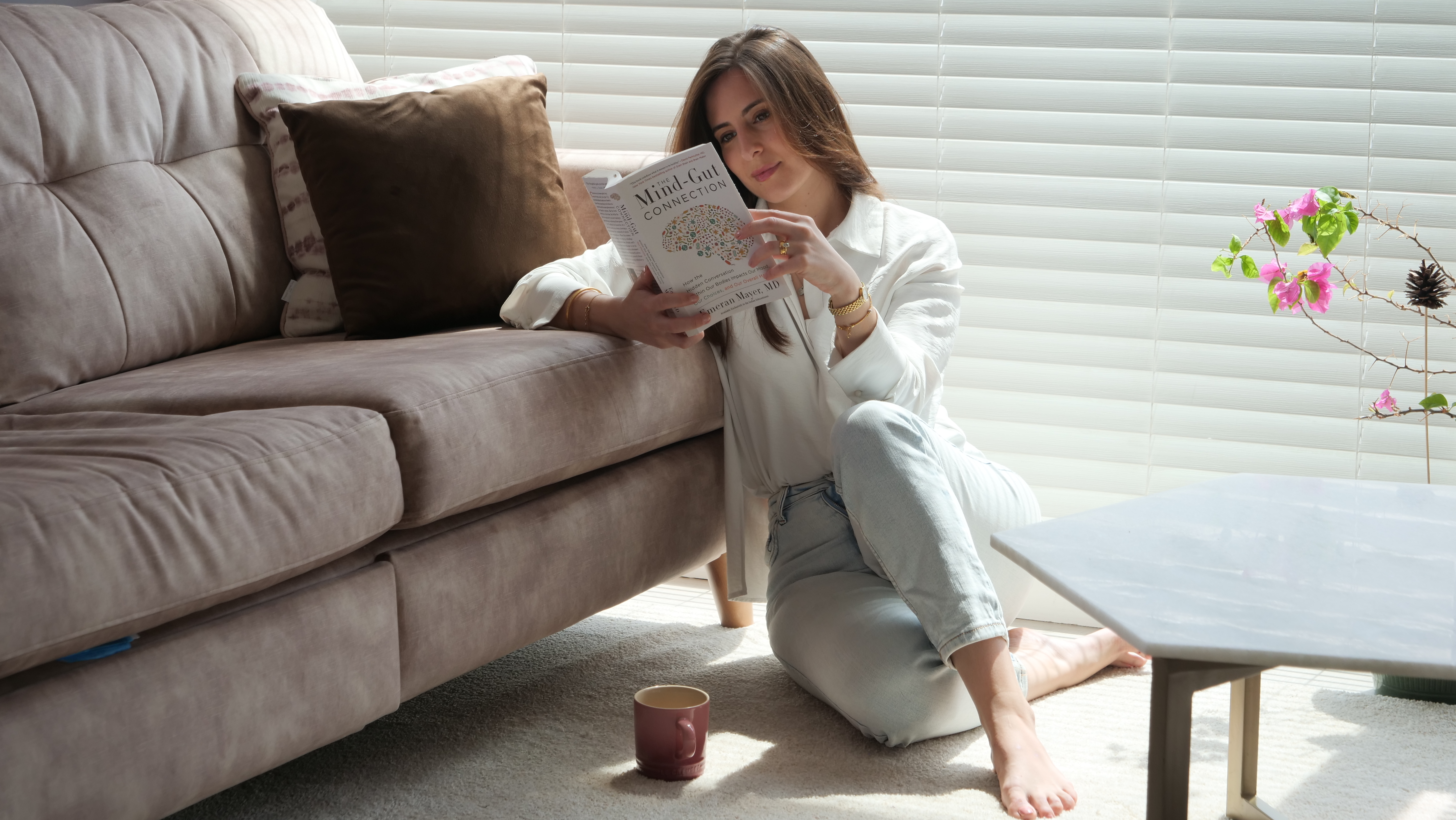 Samantha at home with a warm drink, taking a mindful pause